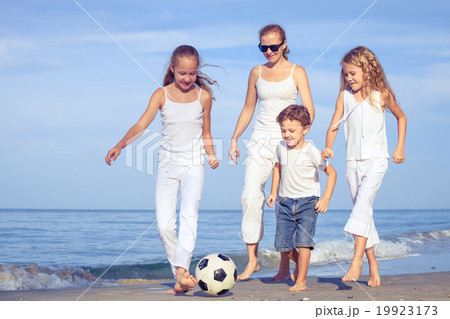 Mother and children playing on the beach at the day time. Mother and children playing on the beach at the day time. 19923173