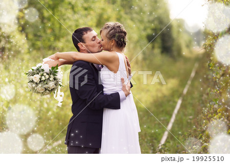 Bride and Groom embracing 19925510