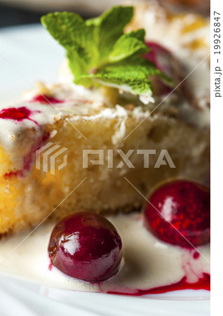 Piece of pineapple pie and cherries on white plate Piece of pineapple pie and cherries on white plate 19926847