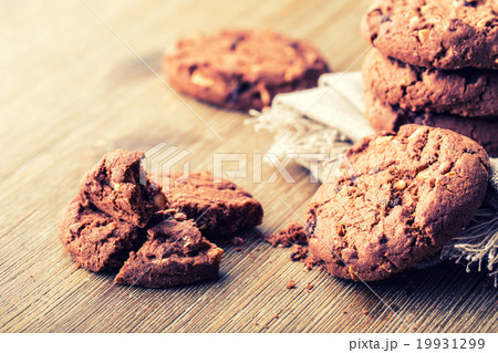 Chocolate cookies on white linen napkin on wooden  19931299