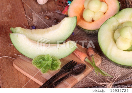 Cantaloupe melon fruit juicy on wood background. 19933725