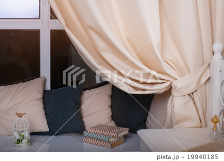 Beautiful curtains and pillows in the room 19940185