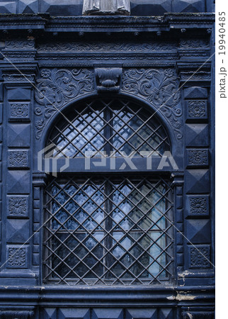 black window with stone stucco plaster patterned 19940485