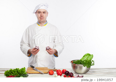 Chef cooking fresh vegetable salad in his kitchen 19941057