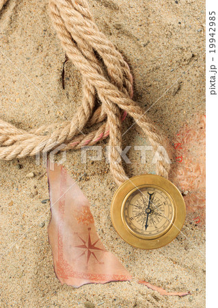set of nautical instruments, lying on the sand and 19942985