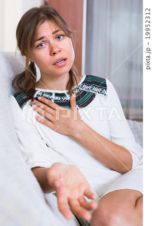 Unhappy brunette in domestic interior. Unhappy brunette in domestic interior. 19952312