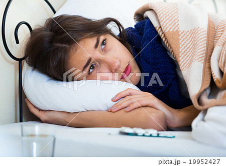 Portrait of miserable girl wth flu at home Portrait of miserable girl wth flu at home 19952427