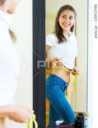 contented girl admires her figure 19952496