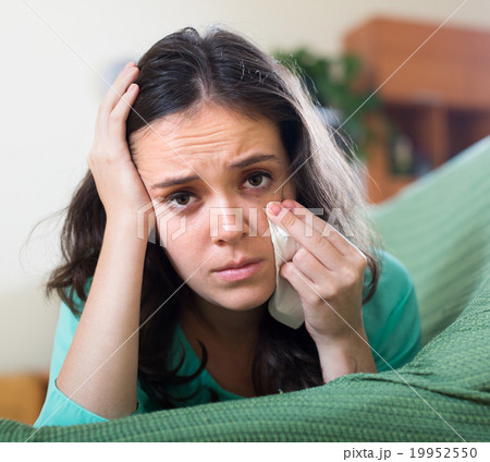 Lonely woman crying on couch 19952550