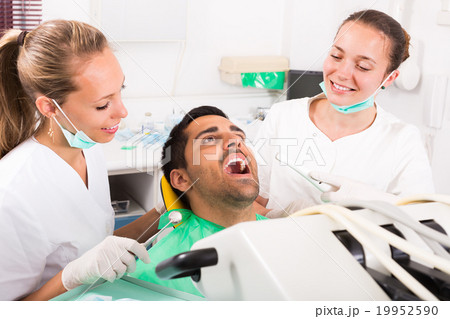 Patient is examined at dental clinic 19952590