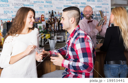 Happy friends drinking and chatting Happy friends drinking and chatting 19953441