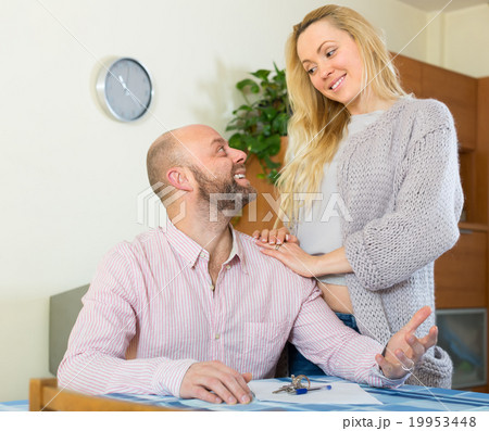 Couple with contract for buying apartment 19953448