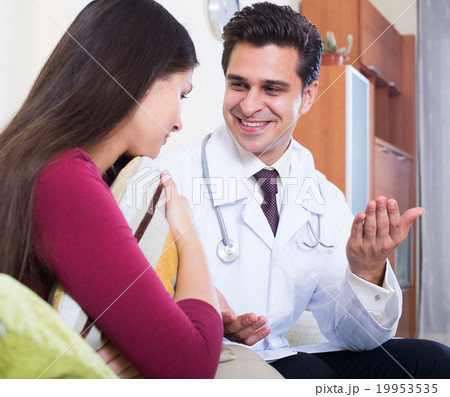 Positive physician consulting sick woman in domestic interior 19953535