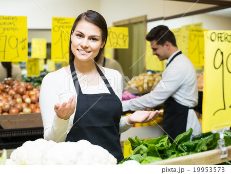 shop people standing near cabbage in grocery 19953573