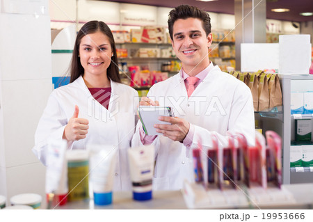 pharmacists posing in drugstore pharmacists posing in drugstore 19953666