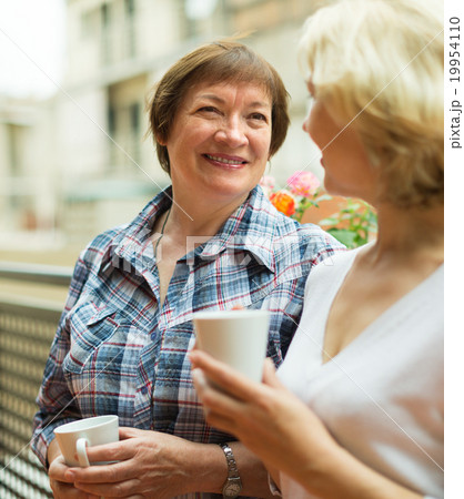 Old women on balcony with coffee 19954110