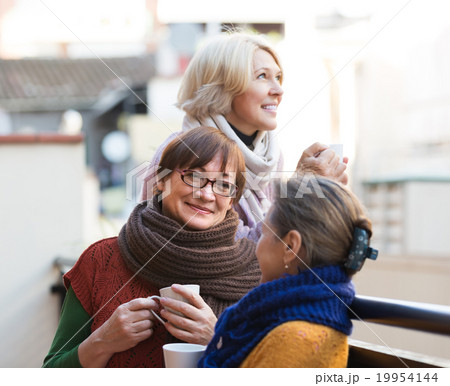 Senior women drinking tea at balcony Senior women drinking tea at balcony 19954144