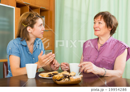 Mother and daughter drink tea 19954286