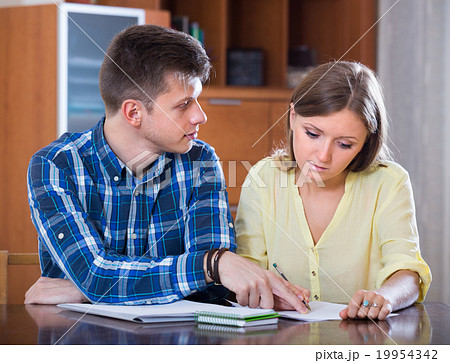 Spouses with documents for bank at home. 19954342