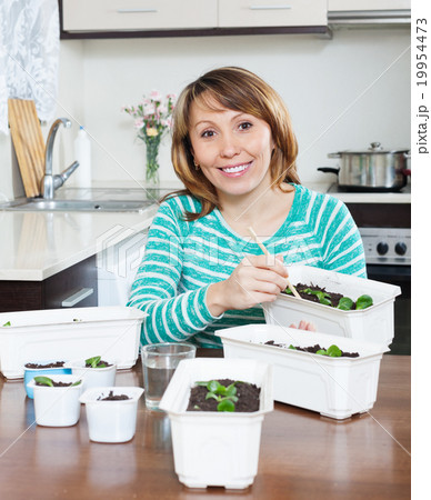 Happy woman working with sprouts Happy woman working with sprouts 19954473