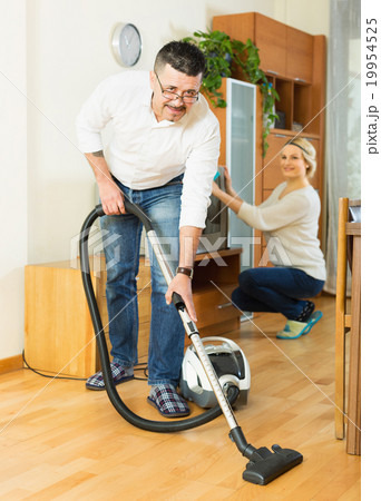 Spouses dusting and hoovering 19954525