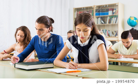 Young students studying in the classroom Young students studying in the classroom 19954870