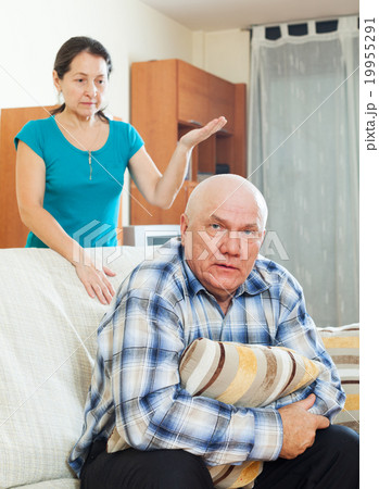 Unhappy senior man with angry wife 19955291