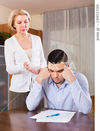 Adult son and senior mother with papers Adult son and senior mother with papers 19955500