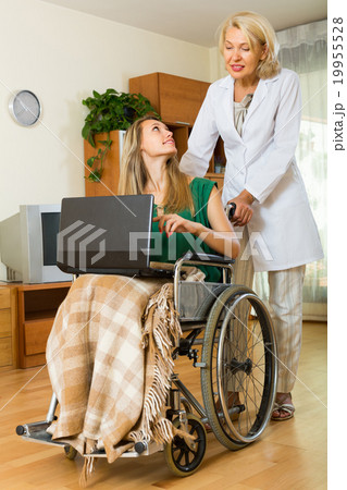Social worker and invalid with laptop Social worker and invalid with laptop 19955528