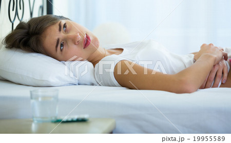 Teenage girl having belly pain and taking pills Teenage girl having belly pain and taking pills 19955589