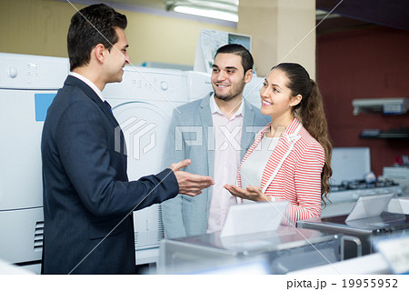 salesman and adult customers in store 19955952
