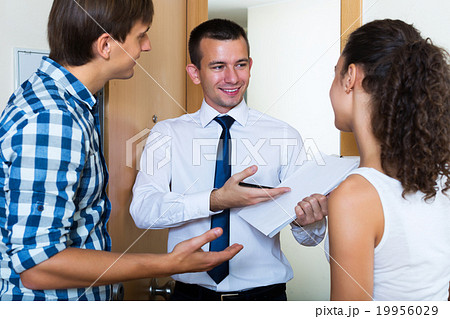 Couple and agent with documents Couple and agent with documents 19956029