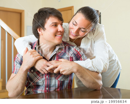 Couple hugging at home. 19956634