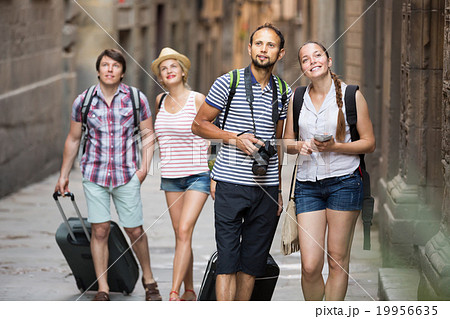Group of happy tourists watching landmark 19956635