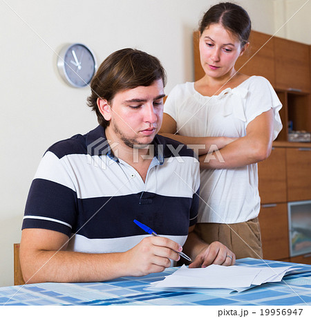 spouses discussing bills 19956947