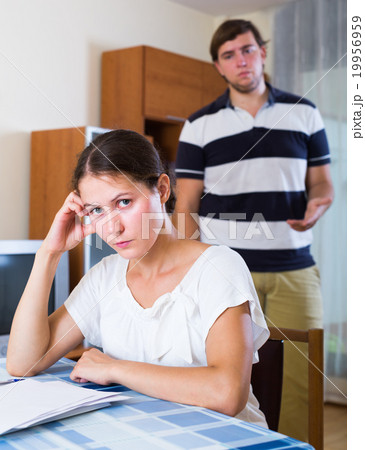 Unhappy woman counting bills with problems 19956959