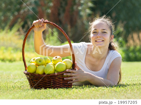 girl with apples harvest in garden 19957205