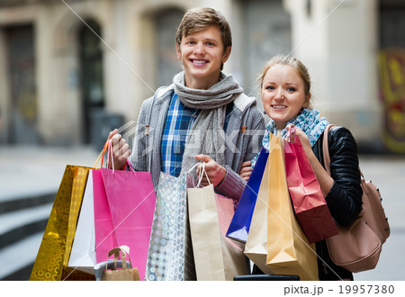 Couple of travellers with shopping bags Couple of travellers with shopping bags 19957380