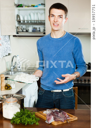Happy man cooking raw squid Happy man cooking raw squid 19957751