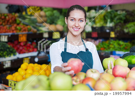 Beautiful sellers apples stacked on the counter Beautiful sellers apples stacked on the counter 19957994