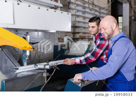 Two men working on machine 19958033