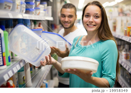 Girl choosing cruet-stands in the shop. Girl choosing cruet-stands in the shop. 19958349