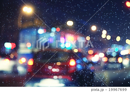 blurred night background city traffic road city lights winter snow glare 19967699
