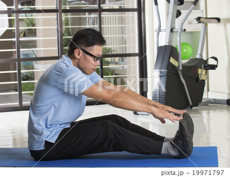 Asian man in sportswear doing leg stretching Asian man in sportswear doing leg stretching 19971797
