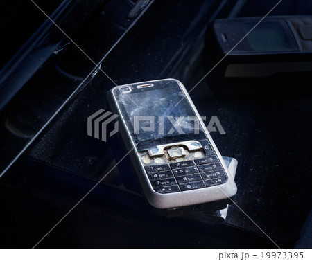 Old mobile phone broken and crack on dust 19973395