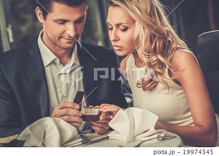 Man holding box with ring making propose to his girlfriend 19974345