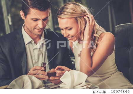 Man holding box with ring making propose to his girlfriend 19974346