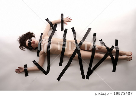 BDSM. Blindfolded nude woman tied with duct tape 19975407