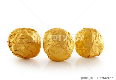 Sweet chocolate candy wrapped in golden foil  19986977
