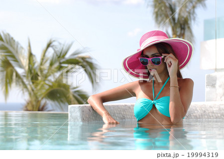 Woman in swimming pool Woman in swimming pool 19994319
